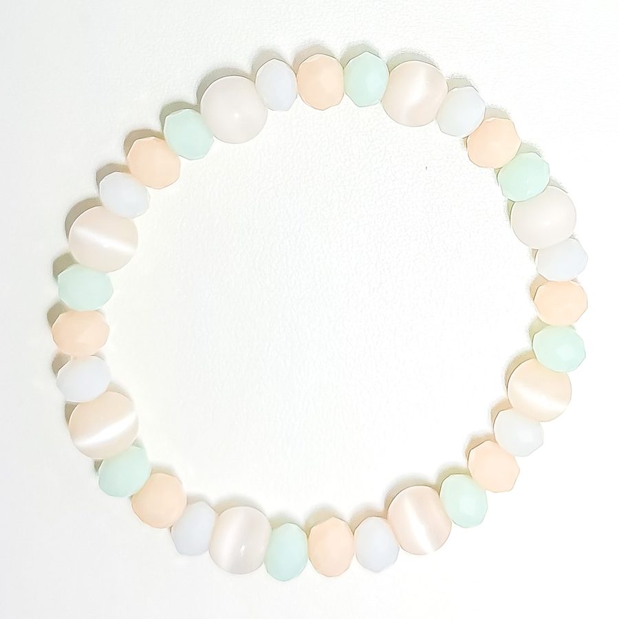 A stretch bracelet of frosted peach, mint, and cream beads in ice cream pastels